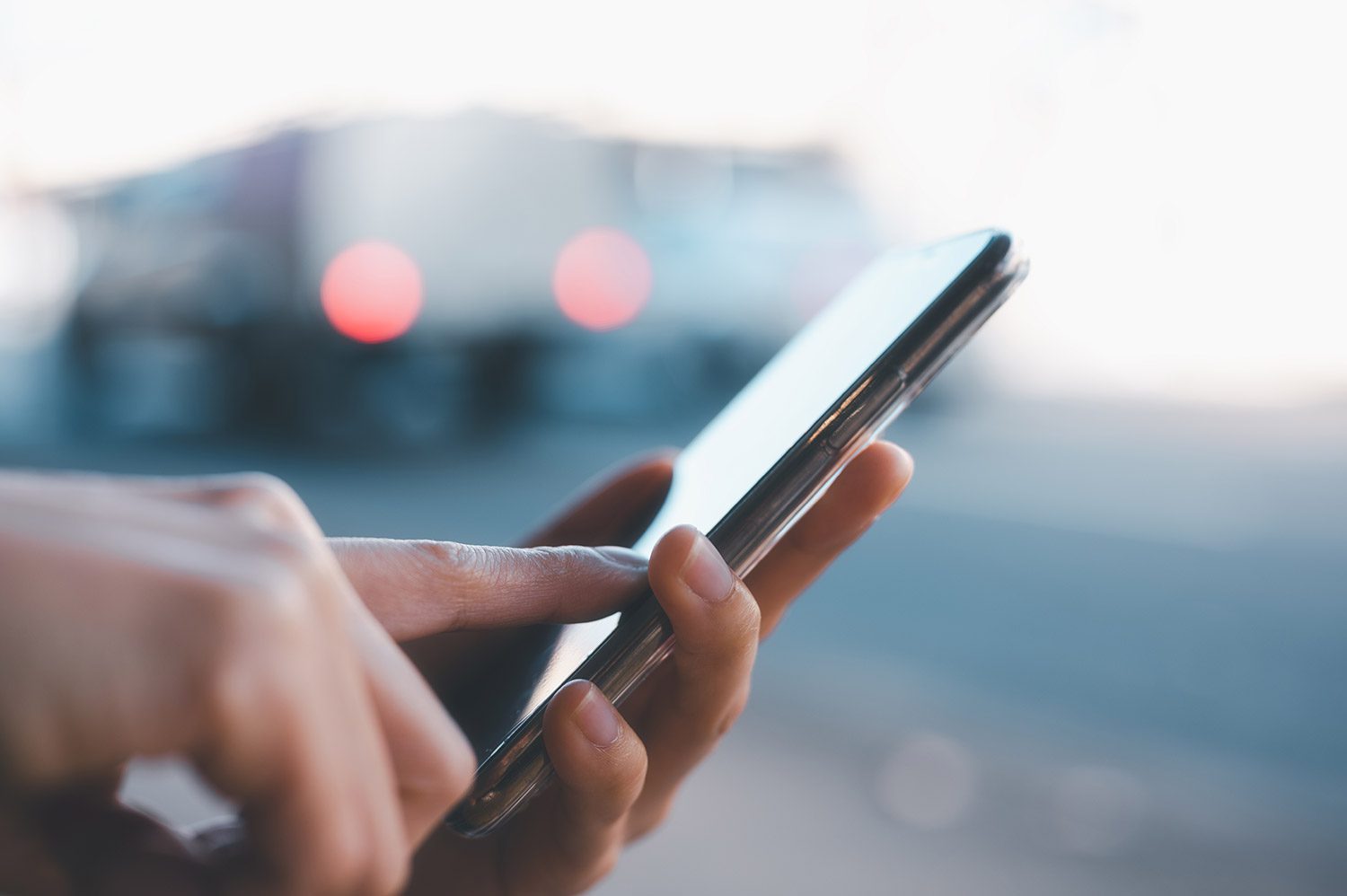 A person typing on a mobile phone