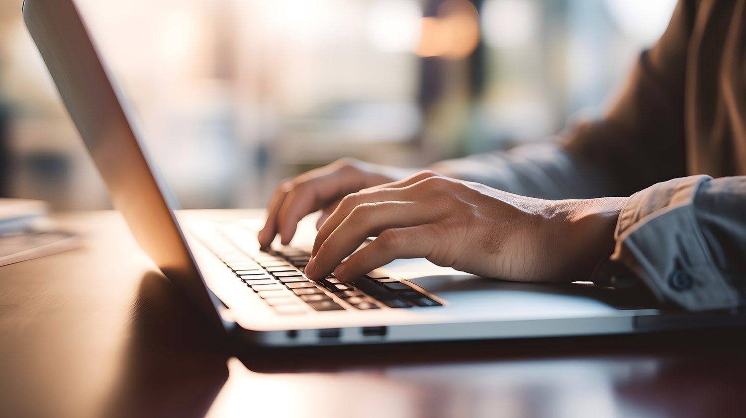 A person typing on a laptop